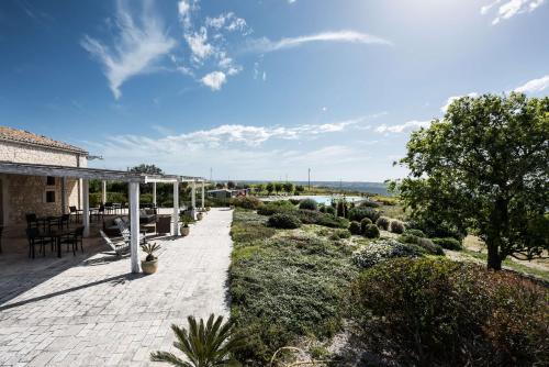 a patio of a house with a table and chairs at La Dimora di Spartivento - BW Signature Collection in Ragusa