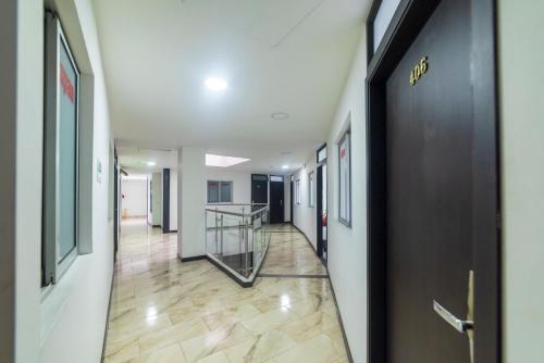 a hallway of an office building with a door and a staircase at Depeapan in Cali