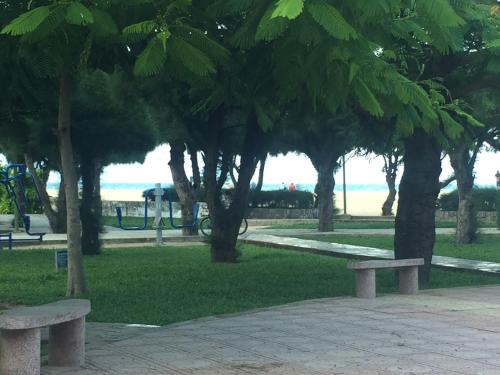 a park with benches and trees and a playground at Khánh An Hotel in Nha Trang