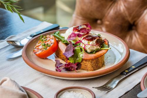 a plate of food with vegetables on a table at Pretty Beach House in Pretty Beach