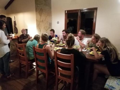 a group of people sitting around a table at Hostel Serena in Samaipata