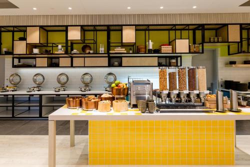 a kitchen filled with lots of plates and bowls at ibis Styles East Perth in Perth
