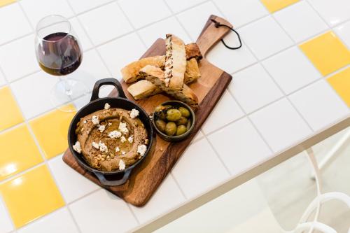 a table with a plate of food and a glass of wine at ibis Styles East Perth in Perth