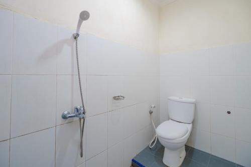 a bathroom with a toilet and a shower at RedDoorz at Sedayu 2 Near Danau Toba Parapat in Parapat