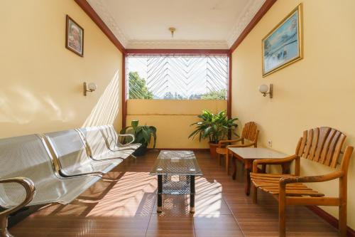 a waiting room with benches and a window at RedDoorz at Sedayu 1 Parapat in Parapat