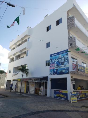 a white building with a kite flying in front of it at A una calle del ado 5ta avenida in Playa del Carmen