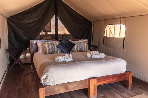 a bedroom with a bed in a tent at Sal Salis Ningaloo Reef in Exmouth