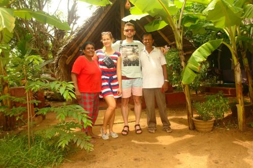 a group of people posing for a picture in a garden at HOMESTAY CAMPING ANURADHAPURA in Anuradhapura