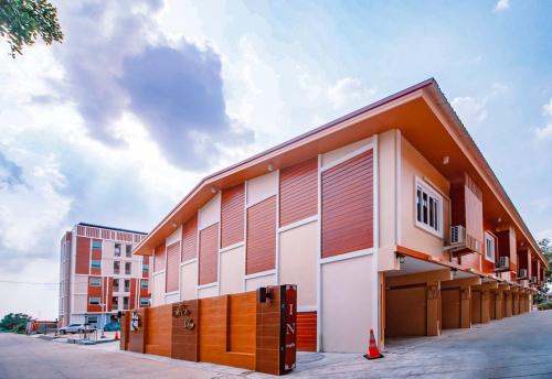 a building with orange and white at Tripletreesvillage in Ban Sai Mai