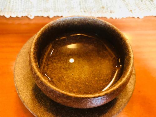 a brown bowl sitting on top of a table at BaHaoBieYuan in Fenghuang