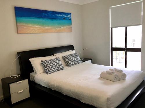 a bedroom with a bed with two towels on it at West Beach Lagoon 218 - Outstanding Value! in Perth