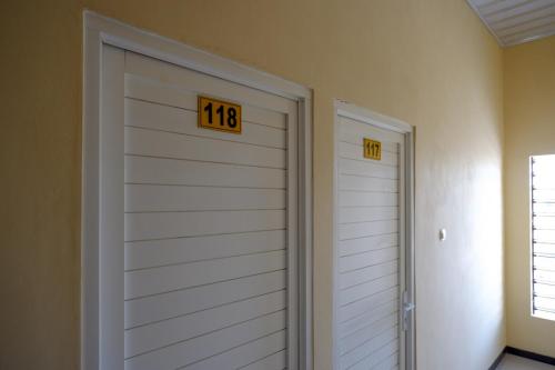 a garage door with the number on it at RedDoorz Syariah near Alun Alun Pati in Pati