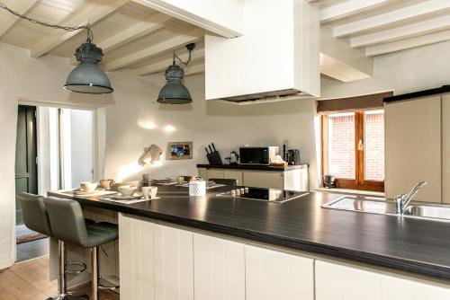 a kitchen with a large black counter top at De Lievensmolen in Damme