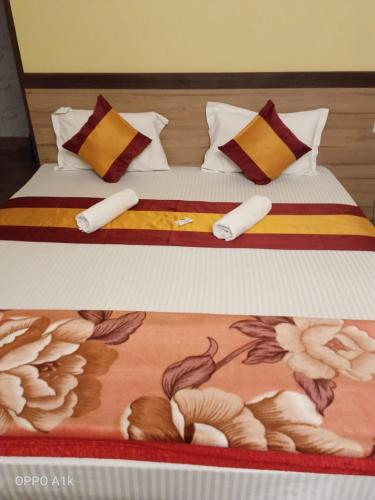 two pictures of a bed with a painting on it at Sundarban Tiger Roar Resort in Purbbadulki