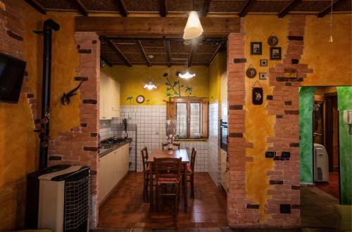 a kitchen with a table and a brick wall at Casa di Pierina in Poggibonsi
