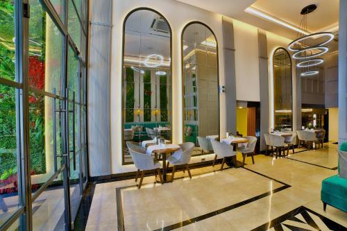 a restaurant with tables and chairs and large windows at SORRISO HOTEL DUE in Istanbul