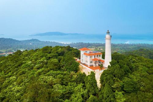 an aerial view of a lighthouse on a hill at Coto Center Homestay in Dao Co To