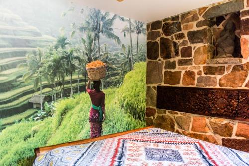 a room with a painting of a woman holding a basket at Bali at the Bay in Nelson Bay