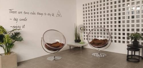 a room with two chairs and a mirror on the wall at Proud Khaoyai in Pak Chong
