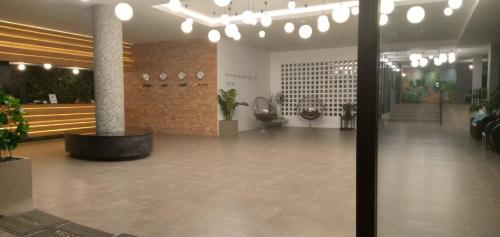 a lobby with a large lobby with potted plants at Proud Khaoyai in Pak Chong