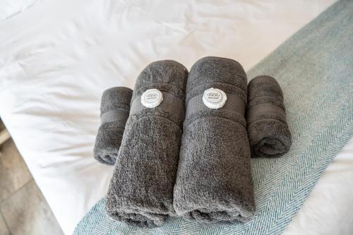 two pairs of socks laying on a bed at Opstal Guestfarm in Potchefstroom