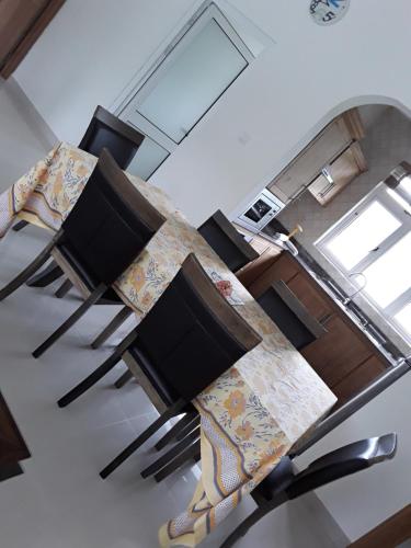 a living room with a table with two televisions at Maison Cattleya Selfcatering Apartment in Mahe