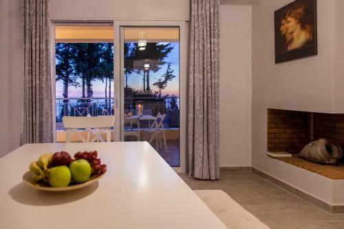a bowl of fruit on a table in a living room with a fireplace at Ble on Blue in Athanion