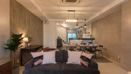 a living room with a couch and a table at Airee Premier Residence in Bangkok