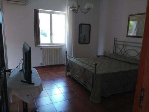 Postel nebo postele na pokoji v ubytování B&B Villa Le Palme Scalea