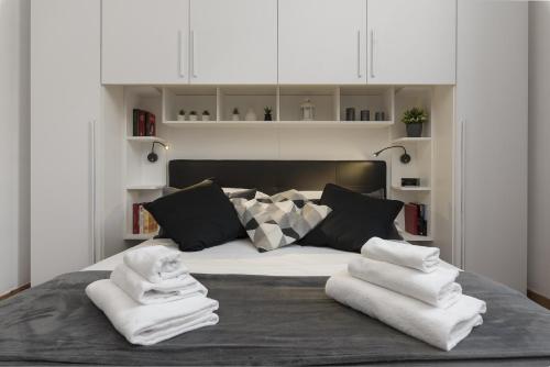 a bedroom with a bed with towels on it at Take You Rome - Vatican Apartment in Rome