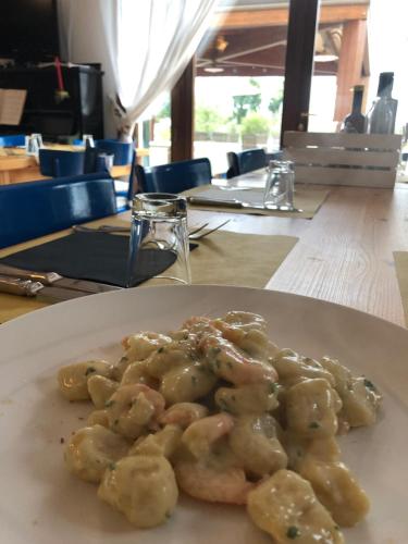 a white plate of food on a table at Country House Salomè in Musile di Piave