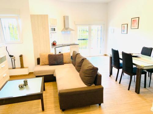 a living room with a couch and a table at Exclusive New Apartment in Benalmádena