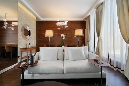 a living room filled with furniture and a large window at Hotel Majestic in Belgrade