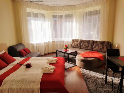 a living room with a bed and a couch at Filaretai Exclusive in Vilnius