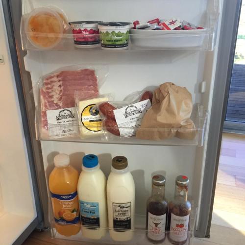 an open refrigerator filled with lots of food and drinks at Barossa Pavilions & Glasshouse in Lyndoch