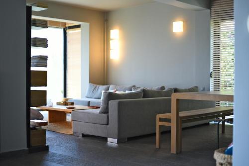 a living room with a couch and a table at Elia Seafront Villa in Elia