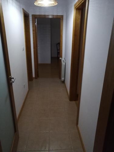 a hallway leading to a room with a tile floor at Congidouro in Freixo de Espada à Cinta