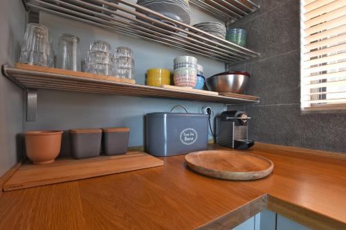 a kitchen counter with a sink and bowls and plates at Elia Seafront Villa in Elia
