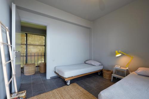 a bedroom with two beds and a balcony at Elia Seafront Villa in Elia
