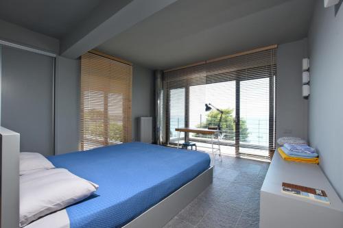 a bedroom with a bed and a large window at Elia Seafront Villa in Elia