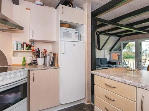 a kitchen with a white refrigerator in a room at 6 person holiday home in R m in Toftum