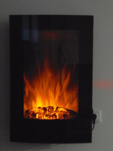 a fire in a fireplace with flames in it at Apartamento en Triana in Seville