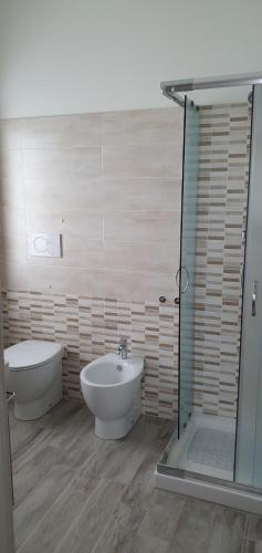a bathroom with a tub and a sink and a shower at Castelvecchio B&B in Sorano