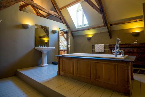 a large bathroom with a tub and a sink at Great House - Grand Georgian House With Outdoor Heated Pool in Laugharne