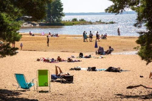 a group of people laying on a beach at Karlstad Swecamp Bomstadbaden in Karlstad