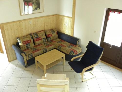 a living room with a couch and a table and chairs at Large chalet with magnificent views in Dabo
