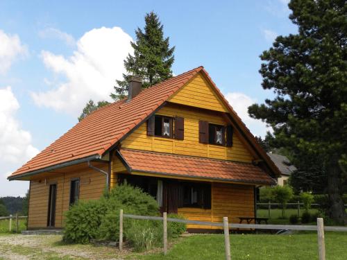 a yellow house with a brown roof at Large chalet with magnificent views in Dabo