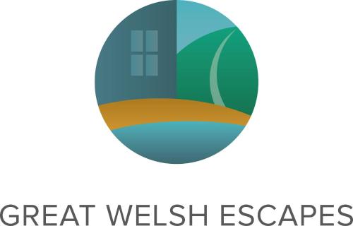 a circle with the text great welsh escapes at Awel Taf- Central cottage ideal for families, with parking in St Clears