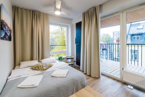 a bedroom with a bed with two towels on it at Thomas' Home - Trendy, Central & Balcony in Tallinn