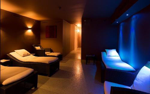 a room with two beds and a blue light at Le Palais Art Hotel Prague in Prague